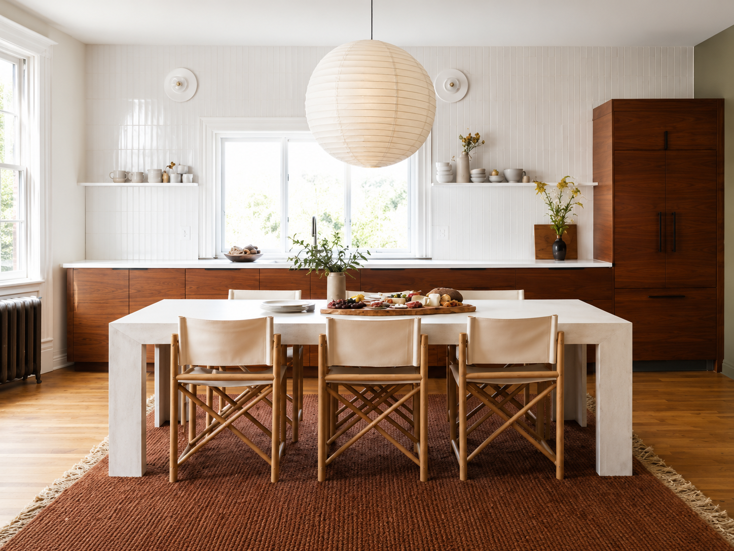 Candlelit dining room with a long oak table at dusk