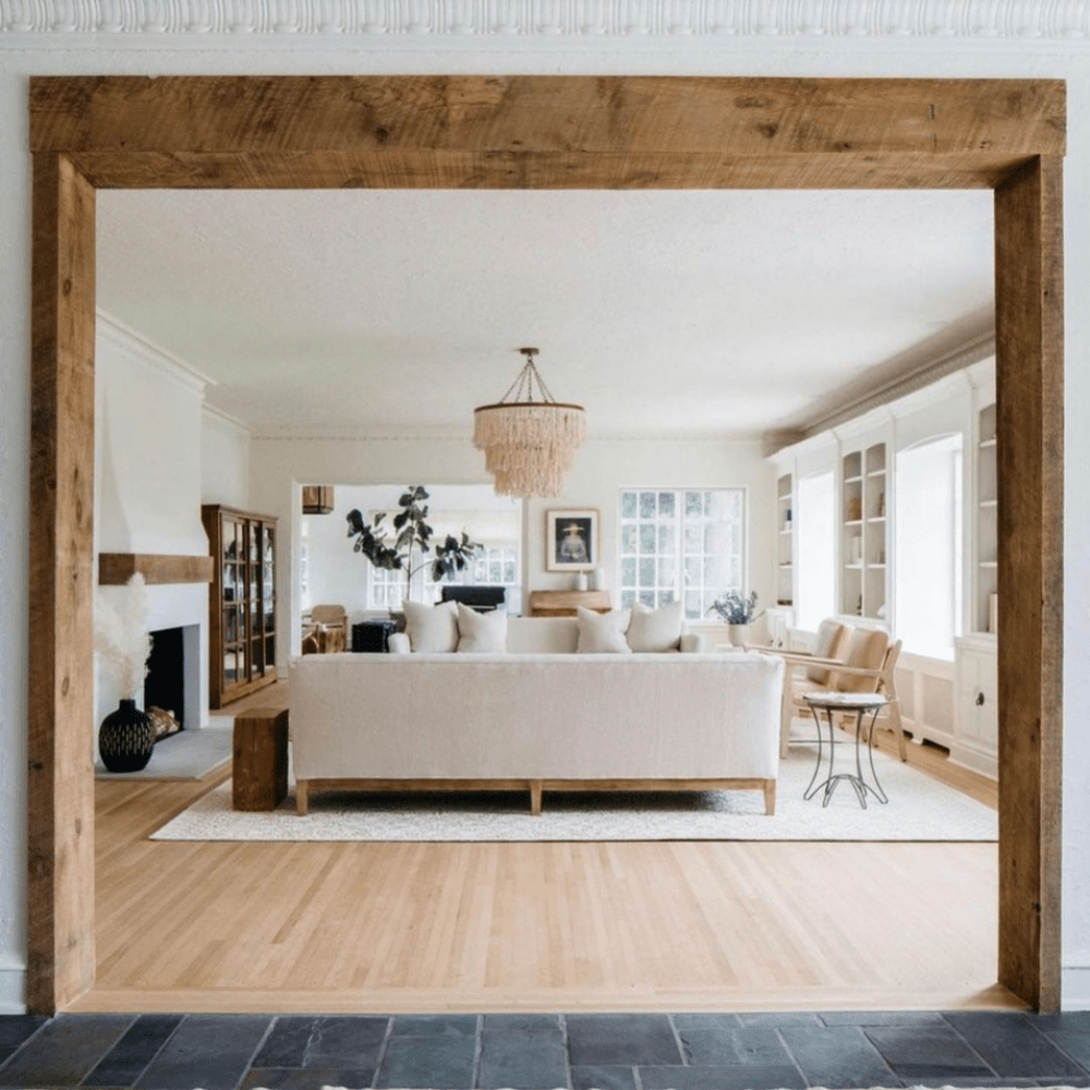 Reclaimed beam framing an open living room.